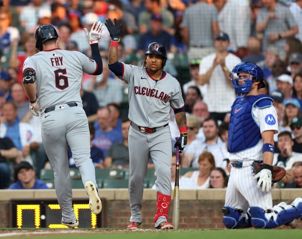 Cleveland Guardians designated hitter David Fry (6) is congratulated by teammate José Ramírez (11) after Fry hit a solo home run in the third inning of a game against the Chicago Cubs at Wrigley Field in Chicago on July 2, 2025. (Chris Sweda/Chicago Tribune)