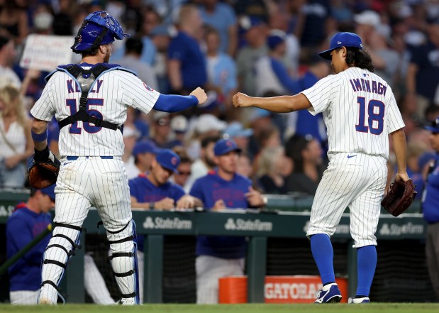 Chicago Cubs catcher Carson Kelly (15) and starting pitcher Shota Imanaga (18) congratulate one another after finishing off the Cleveland Guardians in the fourth inning of a game at Wrigley Field in Chicago on July 2, 2025. (Chris Sweda/Chicago Tribune)