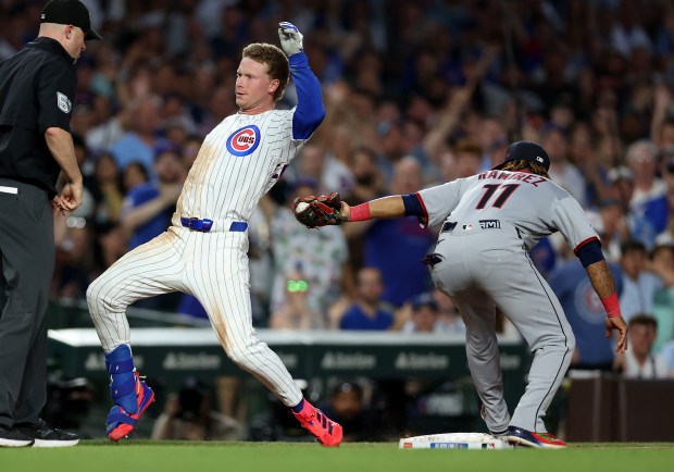 Chicago Cubs center fielder Pete Crow-Armstrong is tagged out by Cleveland Guardians third baseman José Ramírez at third base after Crow-Armstrong came off the base after his run-scoring triple in the fourth inning of a game at Wrigley Field in Chicago on July 2, 2025. (Chris Sweda/Chicago Tribune)