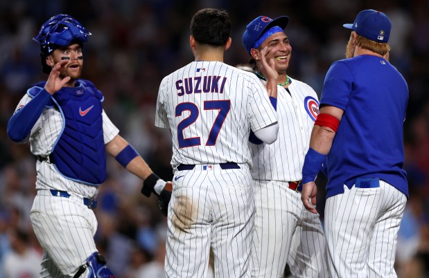Chicago Cubs relief pitcher Daniel Palencia (second from right) celebrates with his teammates after securing a victory by finishing off the Cleveland Guardians in the ninth inning of a game at Wrigley Field in Chicago on July 2, 2025. (Chris Sweda/Chicago Tribune)