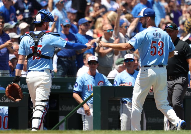 Cubs catcher Carson Kelly fist-bumps starter Colin Rea after the top of the first inning against the Red Sox on July 18, 2025, at Wrigley Field (Chris Sweda/Chicago Tribune)