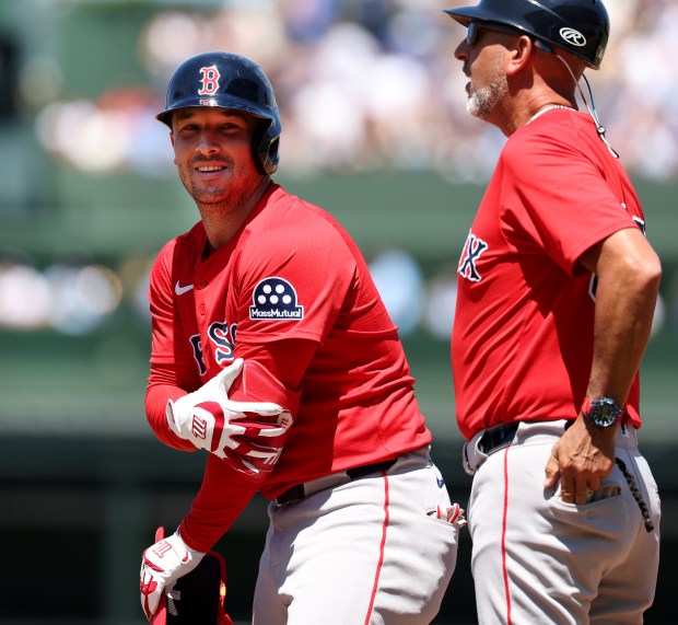 Red Sox third baseman Alex Bregman flashes a smile at first base after he singled in the third inning against the Cubs on July 18, 2025, at Wrigley Field. (Chris Sweda/Chicago Tribune)
