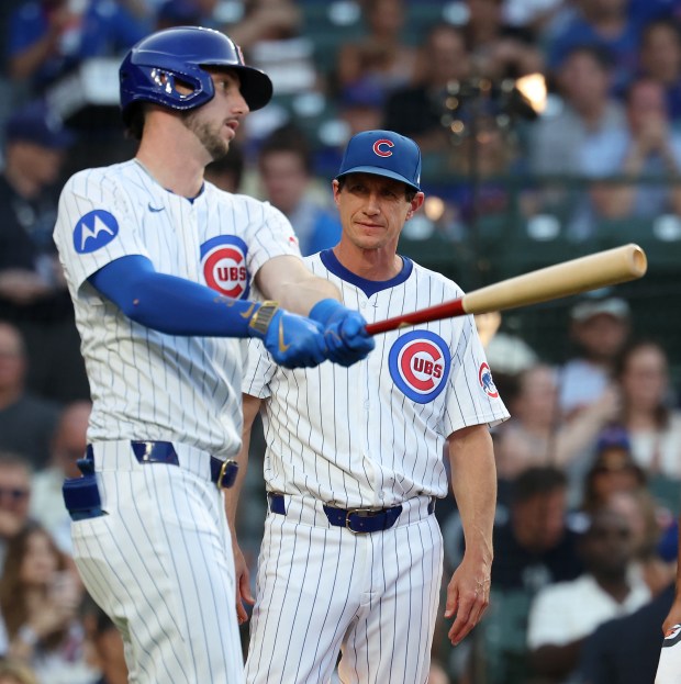 Chicago Cubs manager Craig Counsell checks on Kyle Tucker as the right fielder takes a practice swing after fouling a ball off of himself during an at-bat in the first inning of a game against the Kansas City Royals at Wrigley Field in Chicago on July 22, 2025. (Chris Sweda/Chicago Tribune)