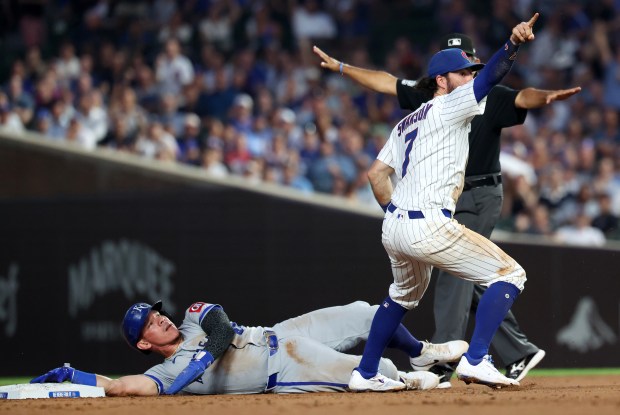 Chicago Cubs shortstop Dansby Swanson reacts after believing he successfully tagged out Kansas City Royals catcher Freddy Fermin at second base for an inning-ending double play in the fifth inning of a game at Wrigley Field in Chicago on July 22, 2025. The umpire called Fermin safe, but a review overturned the call to an out. (Chris Sweda/Chicago Tribune)