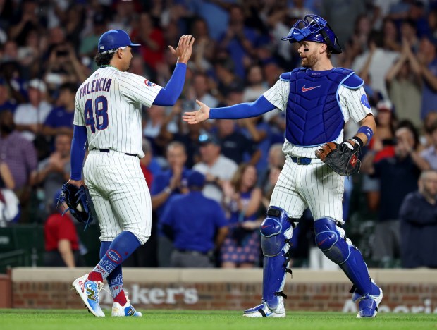 Chicago Cubs relief pitcher Daniel Palencia (48) and catcher Carson Kelly celebrate after securing a victory by closing out the Kansas City Royals in the ninth inning at Wrigley Field in Chicago on July 22, 2025. (Chris Sweda/Chicago Tribune)