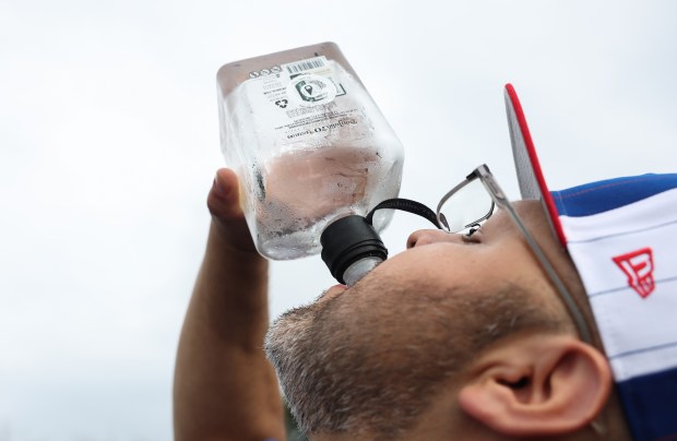 Mike Torres finishes off the final serving from a bottle of tequila while tailgating before a White Sox-Cubs game on July 25, 2025, at Rate Field. (John J. Kim/Chicago Tribune)