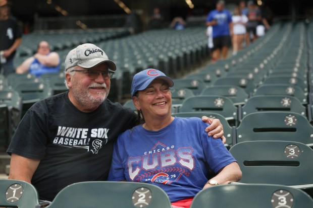 White Sox fan Mike Peters and his wife, Cubs fan Suzy Peters, take their seats for a game on July 25, 2025, at Rate Field. (John J. Kim/Chicago Tribune)
