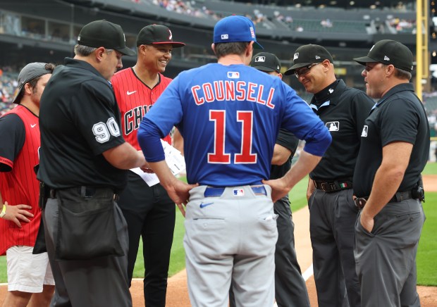 White Sox manager Will Venable, center left, and Cubs manager Craig Counsell exchange lineups and talk with officials before a game on July 25, 2025, at Rate Field. (John J. Kim/Chicago Tribune)