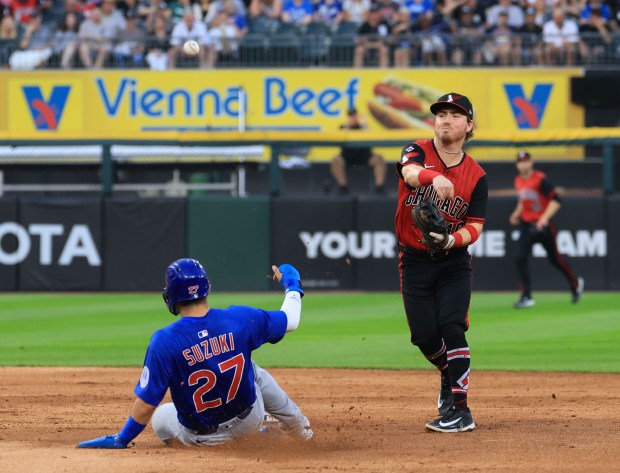 White Sox shortstop Chase Meidroth turns a double play on Cubs designated hitter Seiya Suzuki in the fourth inning on July 25, 2025, at Rate Field. (John J. Kim/Chicago Tribune)