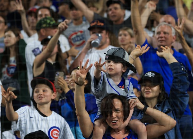 A young Cubs fan wears a rally cap during the seventh-inning stretch of a White Sox-Cubs game on July 25, 2025, at Rate Field. (John J. Kim/Chicago Tribune)