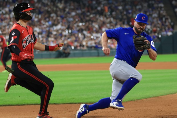 Cubs utility player Jon Berti, right, beats White Sox right fielder Brooks Baldwin to first base for an out while pitching in the eighth inning on July 25, 2025, at Rate Field. (John J. Kim/Chicago Tribune)