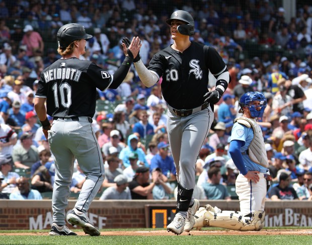 White Sox third baseman Miguel Vargas is congratulated by teammate Chase Meidroth (10) after Vargas hit a two-run home run against the Cubs on May 16, 2025, at Wrigley Field. (Chris Sweda/Chicago Tribune)