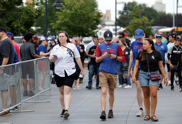 White Sox and Chicago Cubs fans arrive at Rate Field before a City Series game on July 26, 2025. (Chris Sweda/Chicago Tribune)