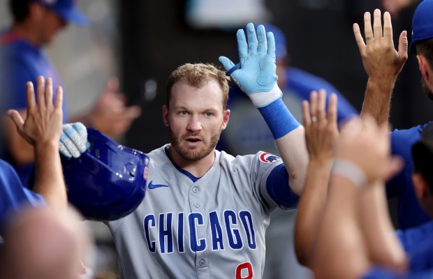 Cubs left fielder Ian Happ high-fives teammates in the dugout after hitting a solo home run in the seventh inning against the White Sox on July 26, 2025, at Rate Field. (Chris Sweda/Chicago Tribune)