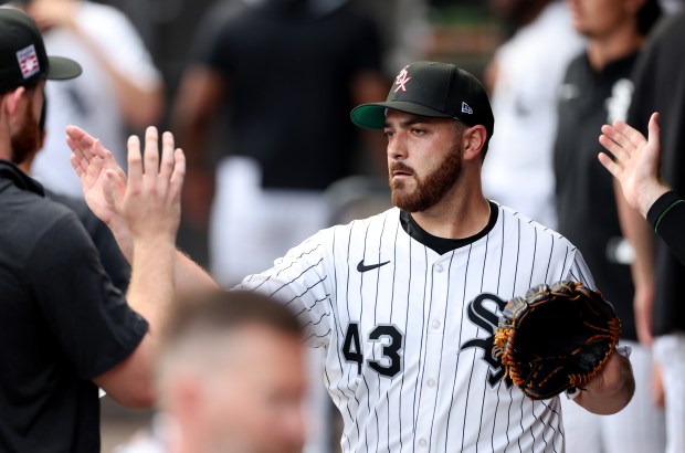 White Sox starter Aaron Civale high-fives teammates in the dugout after the top of the second inning against the Cubs on July 26, 2025, at Rate Field. (Chris Sweda/Chicago Tribune)