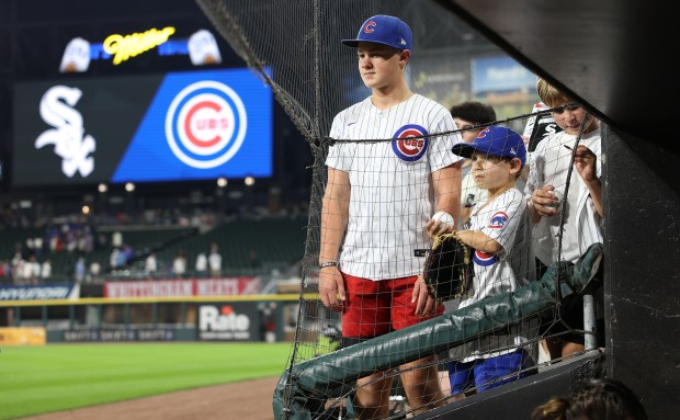 Young Cubs fans hoping to get a glimpse of their favorite players in the dugout stand around after a game against the White Sox on July 26, 2025, at Rate Field. (Chris Sweda/Chicago Tribune)