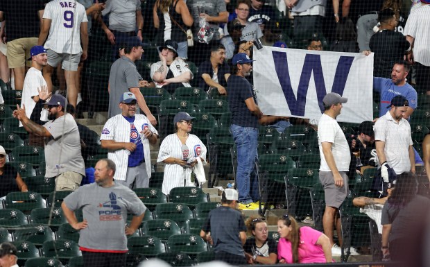 Cubs fans flying a "W" flag after a 6-1 victory over the White Sox on July 26, 2025, at Rate Field. (Chris Sweda/Chicago Tribune)
