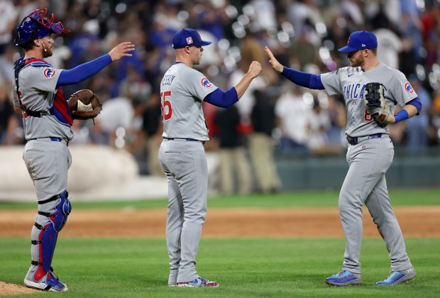 Cubs players Carson Kelly, left to right, Ryan Pressly and Ian Happ celebrate after a 6-1 victory against the White Sox on July 26, 2025, at Rate Field. (Chris Sweda/Chicago Tribune)