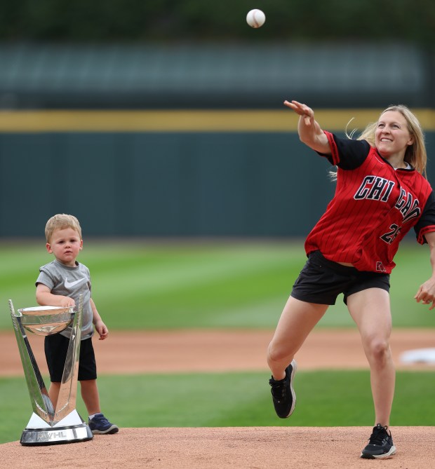With her son Drew watching, professional hockey player Kendall Coyne throws a ceremonial first pitch before a White Sox-Cubs game on July 26, 2025, at Rate Field. (Chris Sweda/Chicago Tribune)