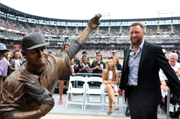Mark Buehrle stands beside a new bronze statue of the former White Sox pitcher that was unveiled along the right-field concourse at Rate Field on July 11, 2025. (Chris Sweda/Chicago Tribune)