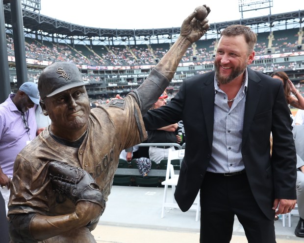 White Sox great Mark Buehrle stands with a new bronze statue of him unveiled along the right field concourse at Rate Field before game two of a doubleheader the Cleveland Guardians on July 11, 2025. (Chris Sweda/Chicago Tribune)