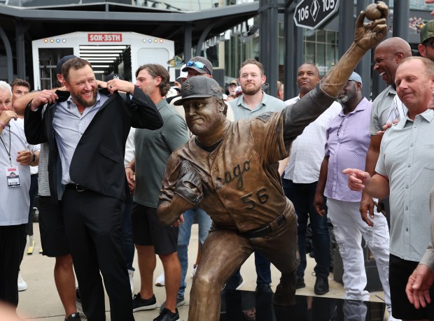 Chicago White Sox great Mark Buehrle, left, laughs with 2005 World Series teammates beside a new bronze statue of him unveiled at Rate Field in Chicago before game two of a doubleheader with the Guardians on July 11, 2025. (Chris Sweda/Chicago Tribune)