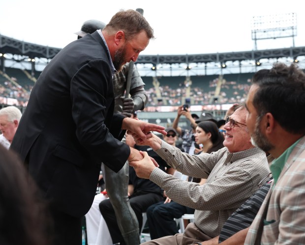 Chicago White Sox great Mark Buehrle greets Sox chairman Jerry Reinsdorf during a statue unveiling ceremony for Buehrle along the right field concourse at Rate Field in Chicago before game two of a doubleheader between the Sox and the Cleveland Guardians on July 11, 2025. (Chris Sweda/Chicago Tribune)