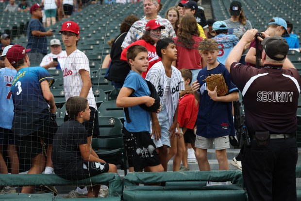 Young fans hoping for player autographs leave the first row seats as rain begins before a White Sox-Phillies game at Rate Field on July 30, 2025, in Chicago. (John J. Kim/Chicago Tribune)