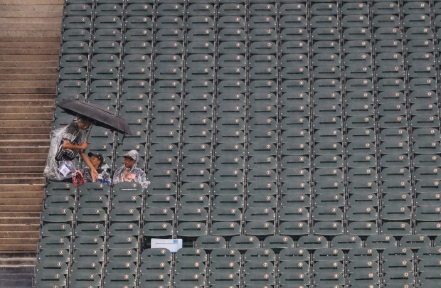 Fans sit in their seats in the left-field bleachers during a rain delay for a White Sox-Phillies game at Rate Field on July 30, 2025, in Chicago. (John J. Kim/Chicago Tribune)
