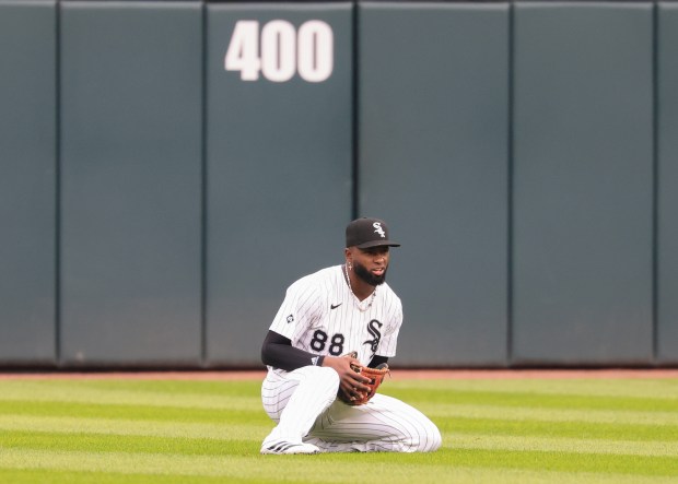 White Sox center fielder Luis Robert Jr. cradles the glove after catching a fly ball from Phillies first baseman Bryce Harper for an out in the first inning at Rate Field on July 30, 2025, in Chicago. (John J. Kim/Chicago Tribune)
