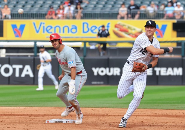 White Sox shortstop Colson Montgomery (12) completes a double play on Phillies third baseman Otto Kemp in the fourth inning at Rate Field on July 30, 2025, in Chicago. (John J. Kim/Chicago Tribune)