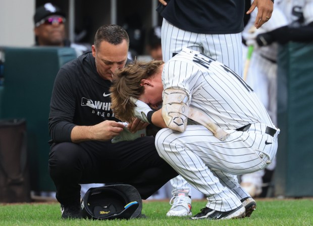 White Sox second baseman Chase Meidroth has his right hand examined after being hit by a pitch in the fifth inning against the Phillies at Rate Field on July 30, 2025, in Chicago. (John J. Kim/Chicago Tribune)