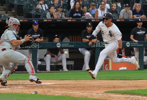 White Sox third baseman Josh Rojas (5) heads for a collision at the plate with Phillies catcher Rafael Marchán, left, in the seventh inning at Rate Field on July 30, 2025, in Chicago. (John J. Kim/Chicago Tribune)