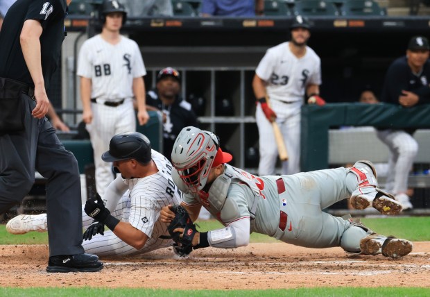 White Sox third baseman Josh Rojas, left, collides at the plate with Phillies catcher Rafael Marchán, right, for an out in the seventh inning at Rate Field on July 30, 2025, in Chicago. (John J. Kim/Chicago Tribune)