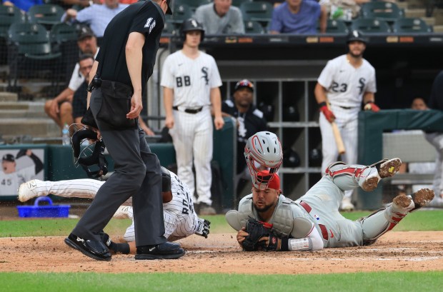 White Sox third baseman Josh Rojas, left, collides at the plate with Phillies catcher Rafael Marchán, right, for an out in the seventh inning at Rate Field on July 30, 2025, in Chicago. (John J. Kim/Chicago Tribune)