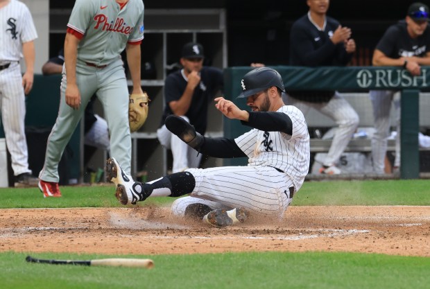 White Sox right fielder Mike Tauchman slides home uncontested on an RBI single from second base Lenyn Sosa in the seventh inning against the Phillies at Rate Field on July 30, 2025, in Chicago. (John J. Kim/Chicago Tribune)
