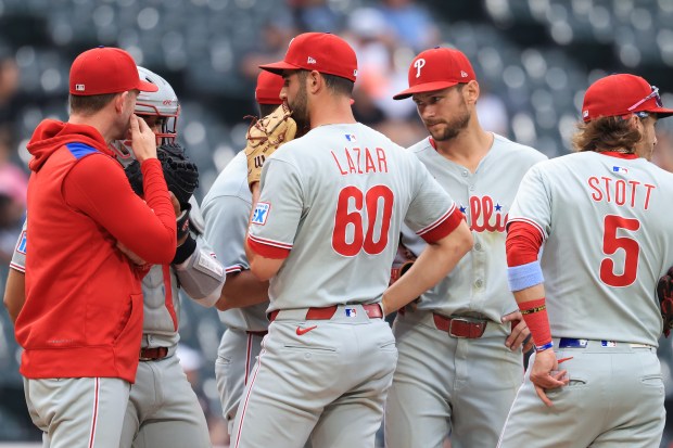 Phillies pitcher Max Lazar takes a meeting on the mound in the seventh inning against the White Sox at Rate Field on July 30, 2025, in Chicago. (John J. Kim/Chicago Tribune)