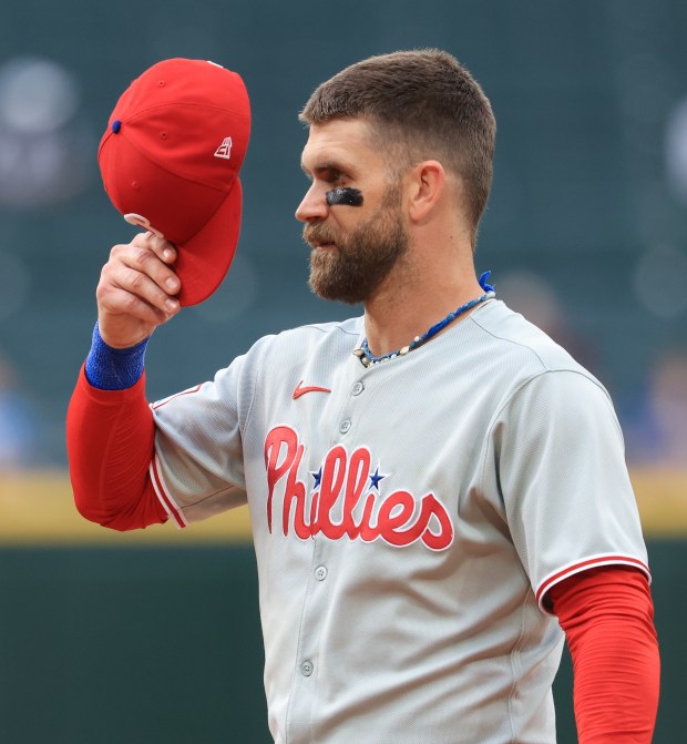 Phillies first baseman Bryce Harper adjusts his cap during a game stoppage in the seventh inning against the White Sox at Rate Field on July 30, 2025, in Chicago. (John J. Kim/Chicago Tribune)