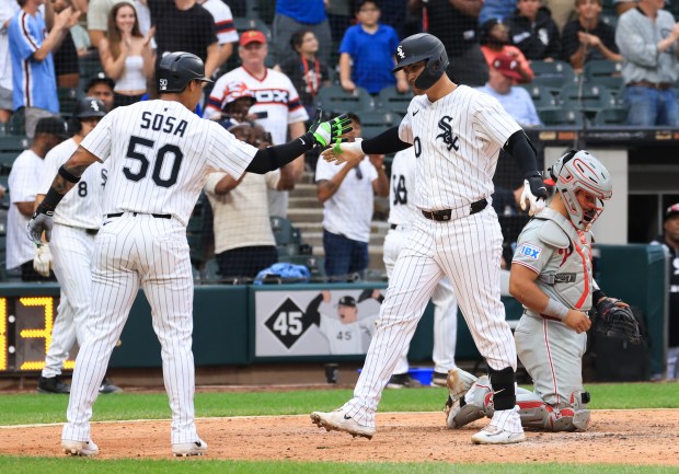 White Sox first baseman Miguel Vargas celebrates with second baseman Lenyn Sosa at the plate after hitting a three-run home run in the seventh inning against the Phillies at Rate Field on July 30, 2025, in Chicago. (John J. Kim/Chicago Tribune)