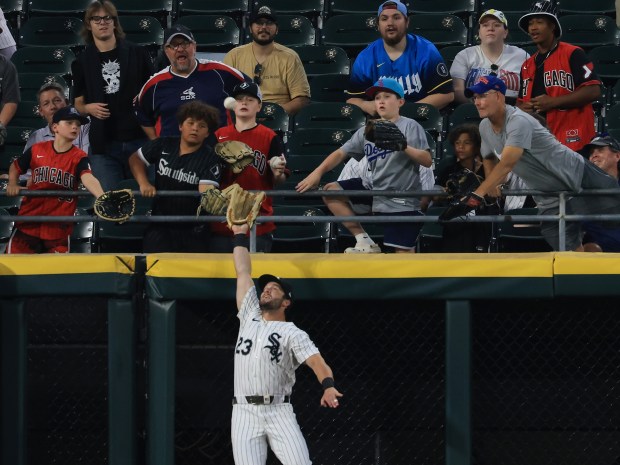White Sox left fielder Andrew Benintendi leaps to catch what would have been a home run ball by Phillies first baseman Bryce Harper for an out in the eighth inning at Rate Field on July 30, 2025, in Chicago. (John J. Kim/Chicago Tribune)