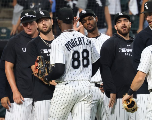 White Sox center fielder Luis Robert Jr. is congratulated by teammates after a 9-3 win over the Phillies at Rate Field on July 30, 2025, in Chicago. (John J. Kim/Chicago Tribune)