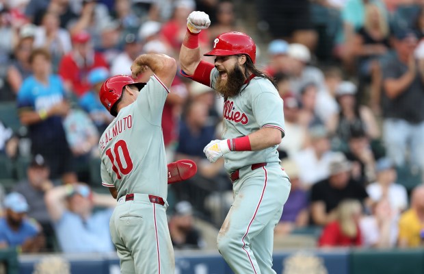 Philadelphia Phillies center fielder Brandon Marsh (right) is congratulated by teammate J.T. Realmuto after Marsh hit a two-run home run in the third inning of a game against the Chicago White Sox at Rate Field in Chicago on July 29, 2025. (Chris Sweda/Chicago Tribune)