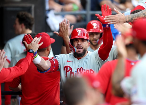 Philadelphia Phillies designated hitter Kyle Schwarber is congratulated by his teammates in the dugout after hitting a two-run home run in the third inning of a game against the Chicago White Sox at Rate Field in Chicago on July 29, 2025. (Chris Sweda/Chicago Tribune)