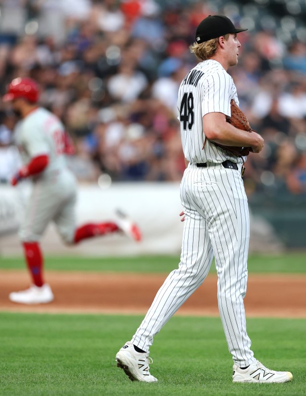 Chicago White Sox starting pitcher Jonathan Cannon walks off the mound as Philadelphia Phillies designated hitter Kyle Schwarber rounds the bases after hitting a two-run home run in the third inning of a game at Rate Field in Chicago on July 29, 2025. (Chris Sweda/Chicago Tribune)