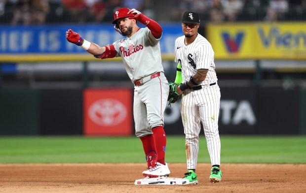 Chicago White Sox second baseman Lenyn Sosa (right) stands by as Philadelphia Phillies designated hitter Kyle Schwarber celebrates at second base after his double in the seventh inning of a game at Rate Field in Chicago on July 29, 2025. (Chris Sweda/Chicago Tribune)