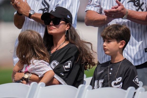 The family of the late Chicago White Sox pitcher Bobby Jenks, his wife Eleni and children Kate and Zeno, are recognized during a ceremony honoring the 2005 World Series Champions before a baseball game between the Cleveland Guardians and the White Sox, Saturday, July 12, 2025, in Chicago. (AP Photo/Erin Hooley)
