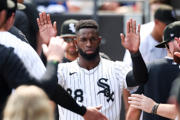 Chicago White Sox outfielder Luis Robert Jr. (88) gets high-fives after hitting an RBI double to tie the game in the eighth inning against the Cleveland Guardians at Rate Field on Sunday, July 13, 2025. (Eileen T. Meslar/Chicago Tribune)