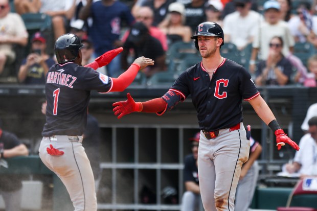 Cleveland Guardians outfielder Angel Martínez (1) celebrates scoring a run with outfielder Nolan Jones (22) in the tenth inning against the Chicago White Sox at Rate Field on Sunday, July 13, 2025. (Eileen T. Meslar/Chicago Tribune)
