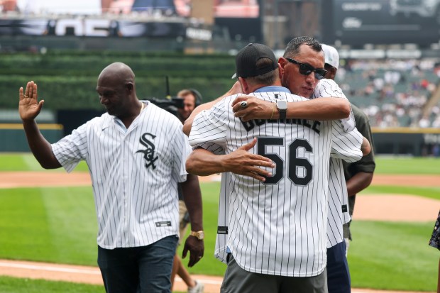 Former Chicago White Sox pitchers Mark Buehrle and Freddy García hug after throwing out the first pitch together before the game against the Cleveland Guardians at Rate Field on Sunday, July 13, 2025. (Eileen T. Meslar/Chicago Tribune)