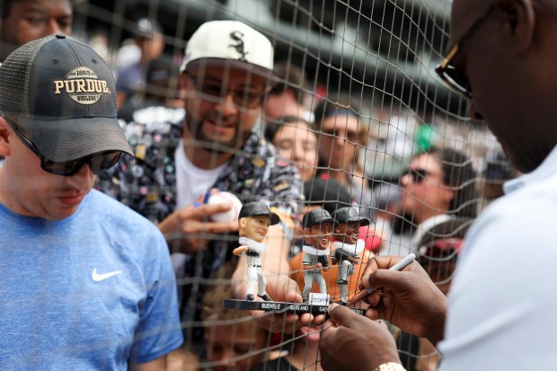 Former Chicago White Sox pitcher José Contreras signs a bobble head before the game against the Cleveland Guardians at Rate Field on Sunday, July 13, 2025. (Eileen T. Meslar/Chicago Tribune)